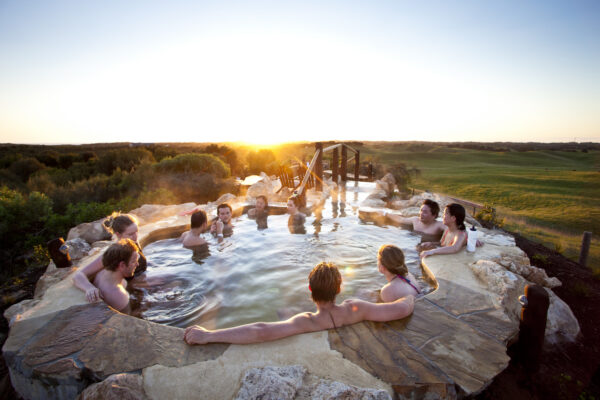RS723_Peninsula Hot Springs - Group enjoying sunset in the hilltop pool-lpr