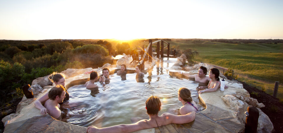 RS723_Peninsula Hot Springs - Group enjoying sunset in the hilltop pool-lpr